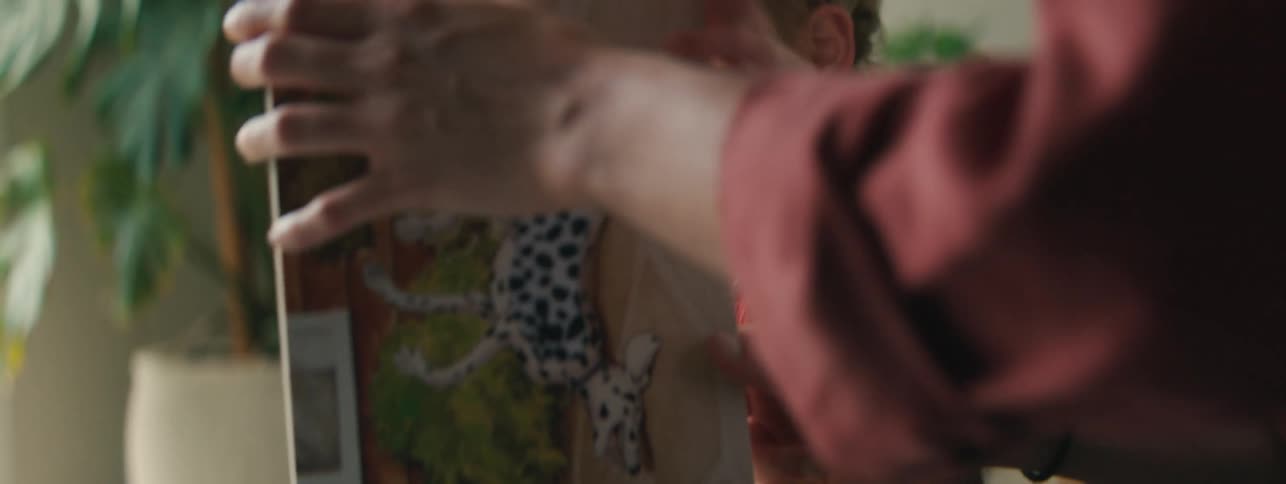 Mother opening a book next to her little daughter