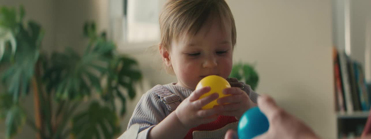 Little child playing with balls
