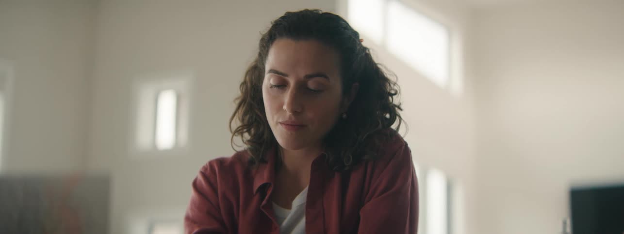 Calm woman with curly hair enjoying a quiet wellness moment.