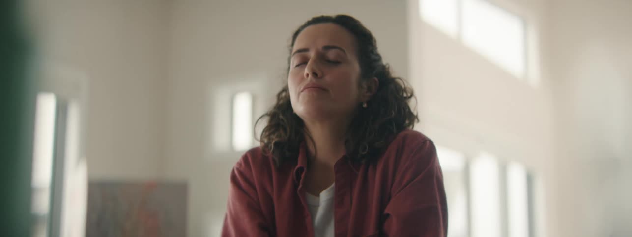 Sad woman sitting alone reflecting on depression and loneliness.