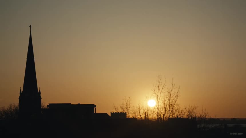 View of the top of a church on a cloudy sky at sunset