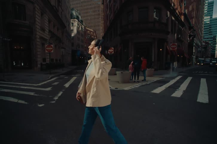 A clip of a lady walking on the tarred road