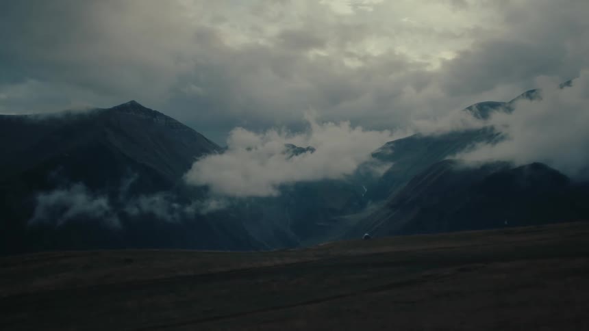 Mountainous landscape with low clouds