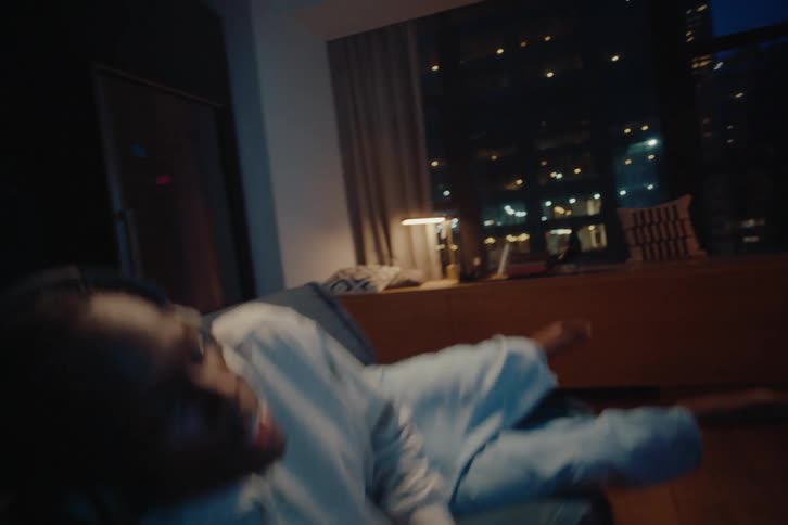 A man sits on the couch playing videogames