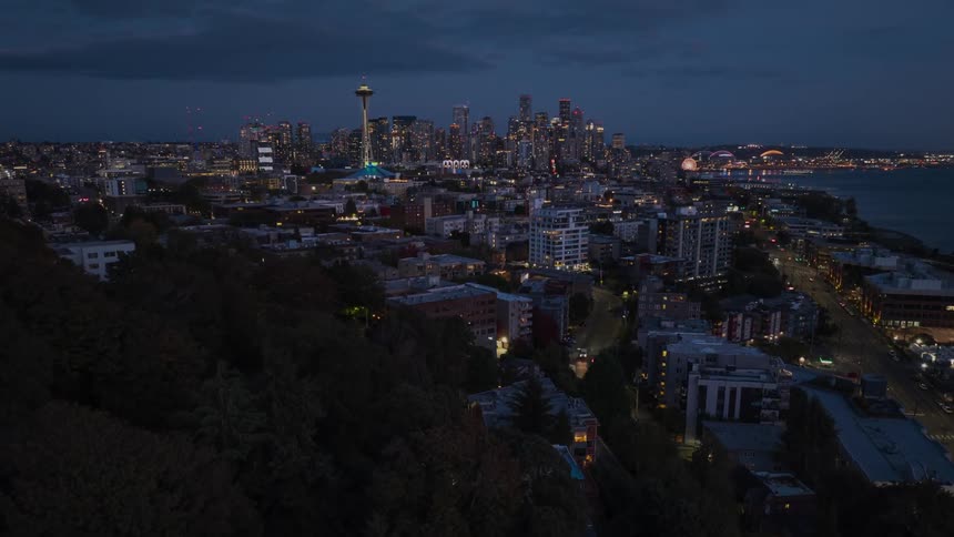 Skimming over the tree line of Queen Anne hill next to Interbay while approaching downtown Seattle