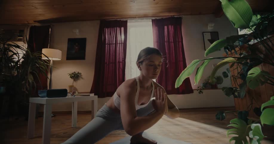 A woman is doing yoga at home
