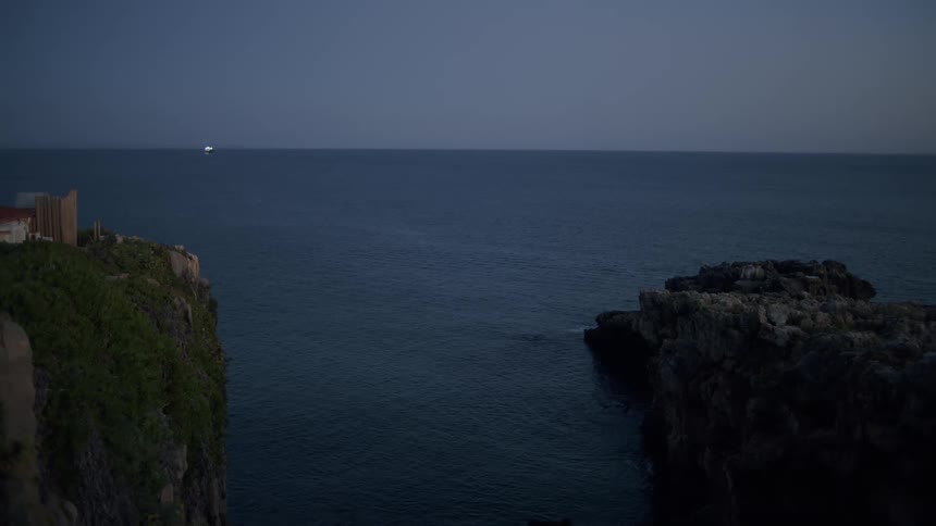 Sea landscape with rocky coast and dark sky