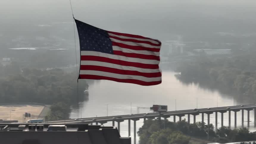 The wind blows the flag high in the sky