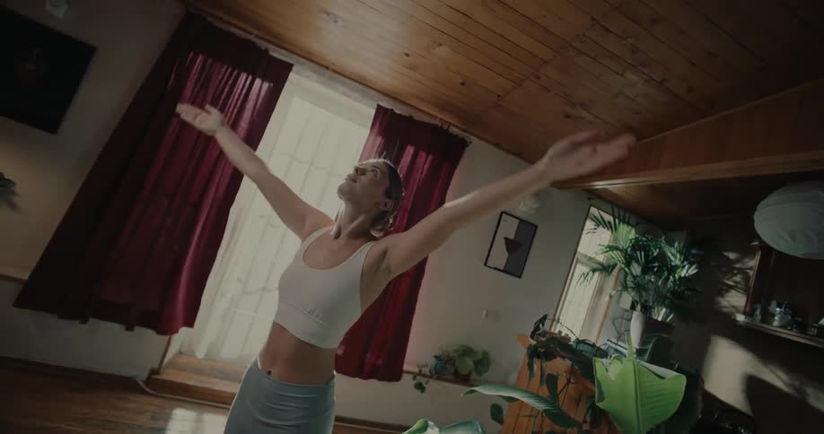 Woman with eyes closed concentrating and doing yoga movements
