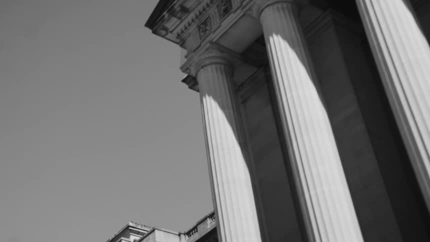 A large building is lined with pillars