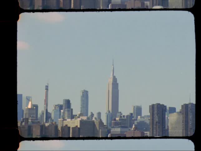 A large downtown area with skyscrapers on the coast of a body of water