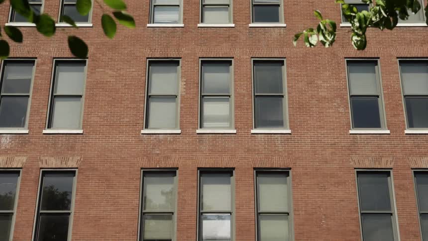 A tall brick building with multiple windows