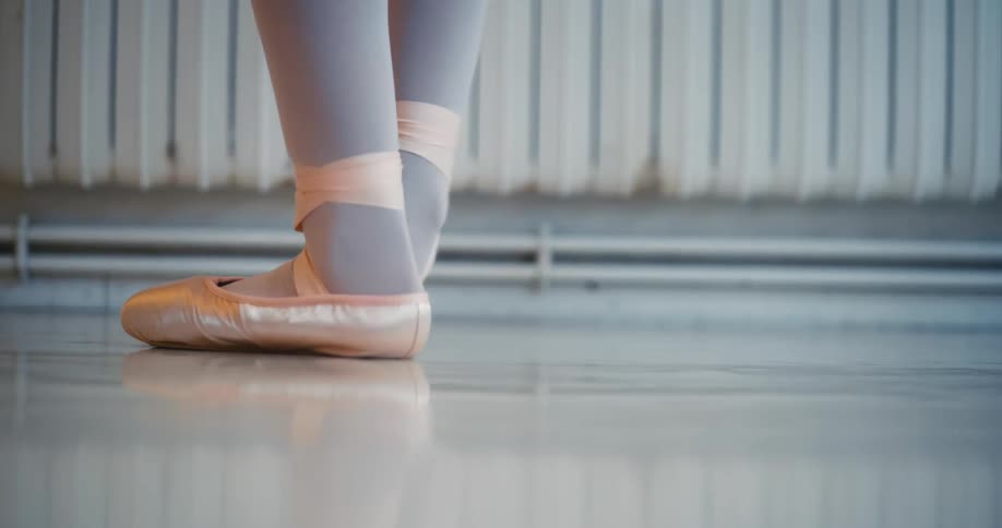 Closeup of a ballerinas feet in pink ballet shoes