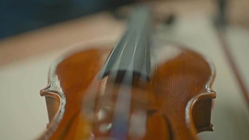 Close up of a varnished wooden violin musical instrument