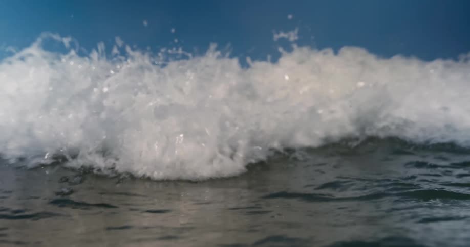 A large fast ocean wave comes crashing forward