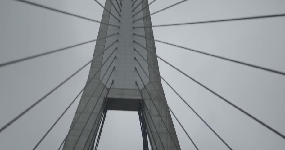 View of a flag atop part of a tall bridge