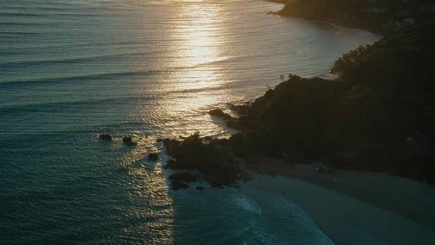 Aerial panorama of the seaside coastline with the sun on the horizon