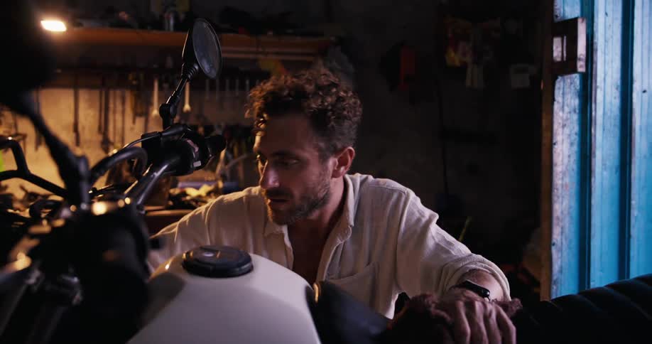 A man is fixing his motorcycle