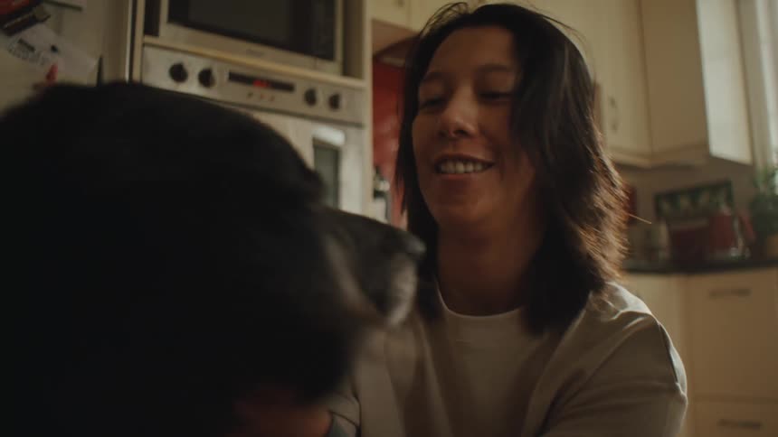 Person crouching down petting a dog