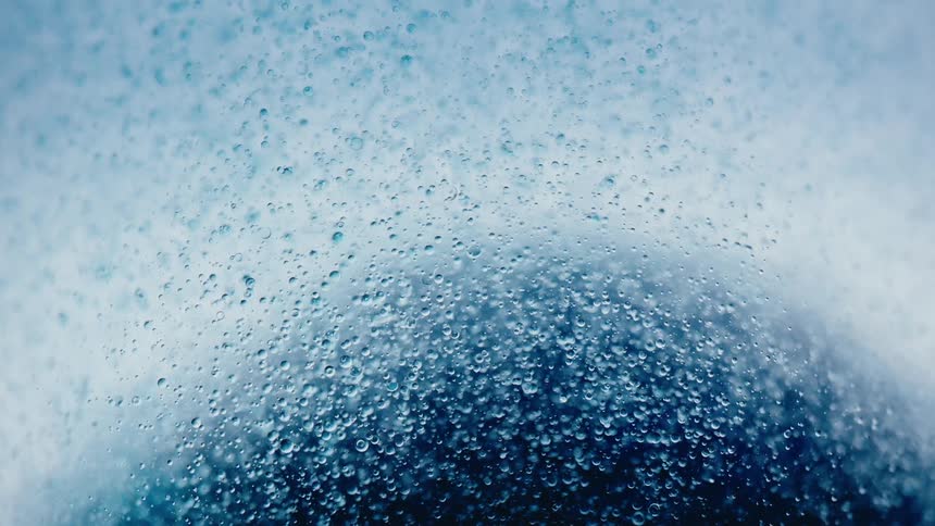 Extreme close up of a liquid with small balls