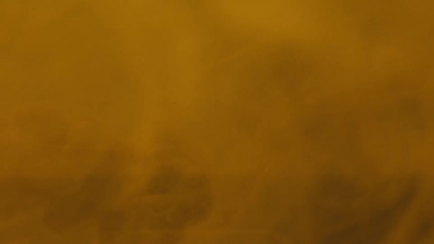 Abstract object in a dense yellowish liquid