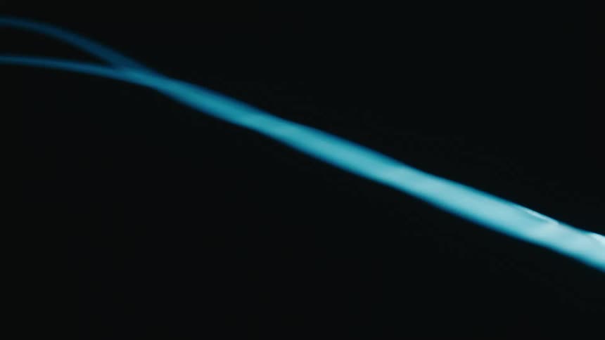 Reflection of a blue light against a black background
