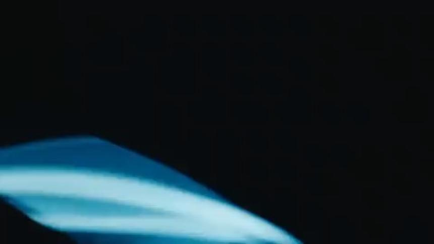 Blue light rotating in a dark environment