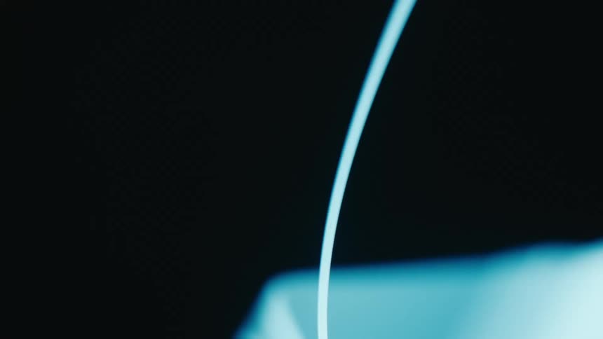Two curved glowing blue lines spinning against a dark background