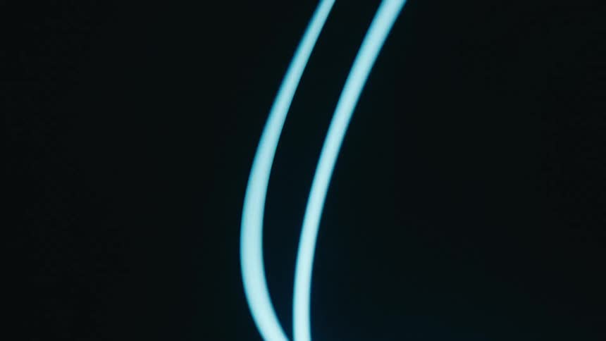 Laser bands whip around in darkness