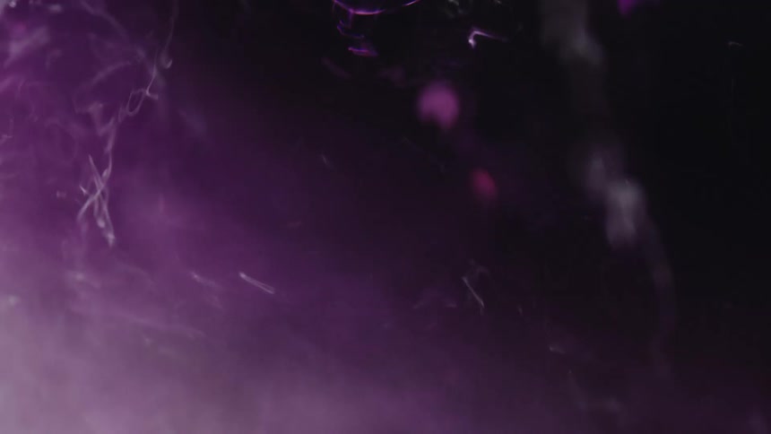 Purple tinted fluid sparkles as it churns and flows