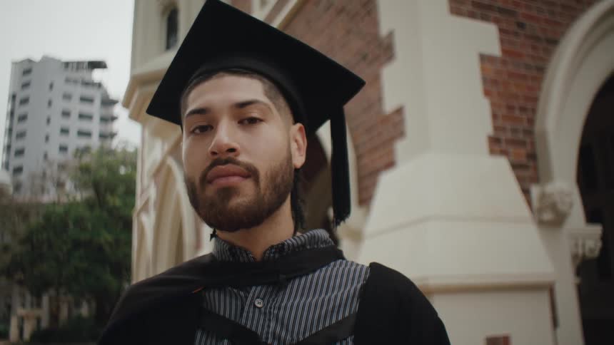 Bearded man in graduation gown