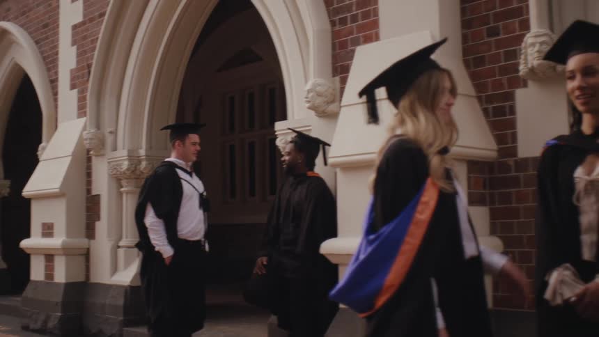Students talking outdoors with graduation committee