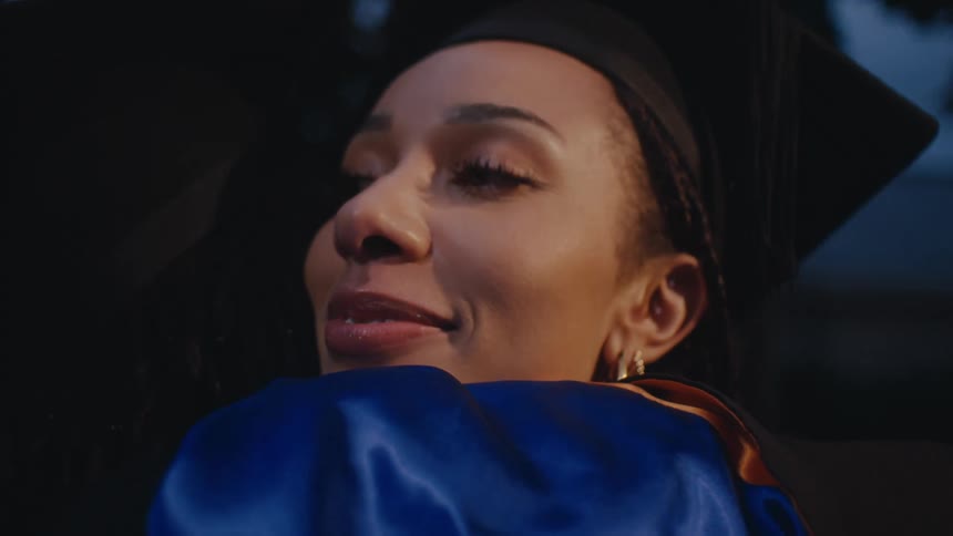 Two graduates hug outside