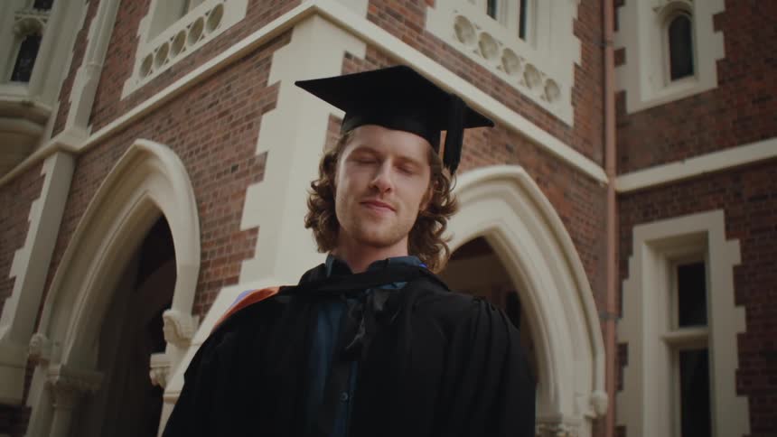 Man dressed in graduation gown