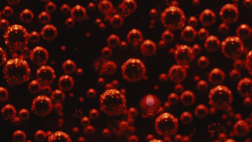 A multitude of tiny glowing spheres dance and shimmer in the depths of a mysterious inky liquid