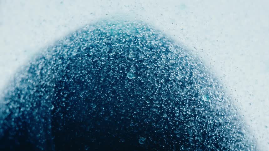 White and blue liquid with thousands of bubbles