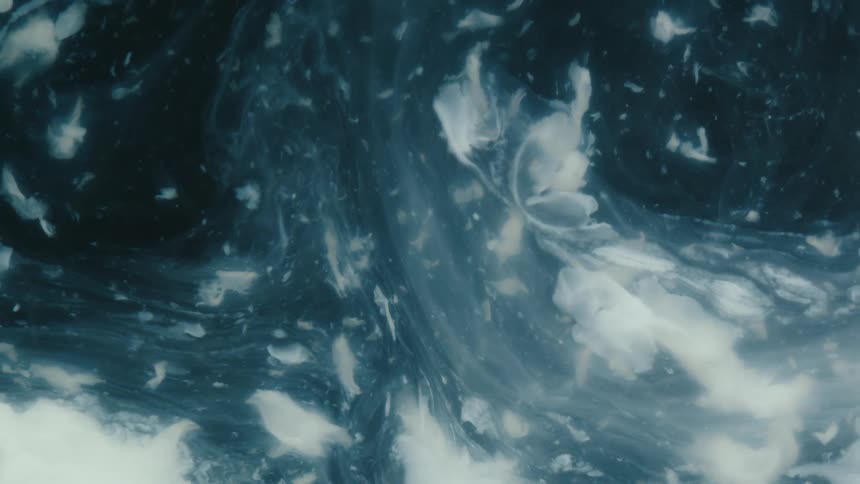 Abstract white particles in liquid movement