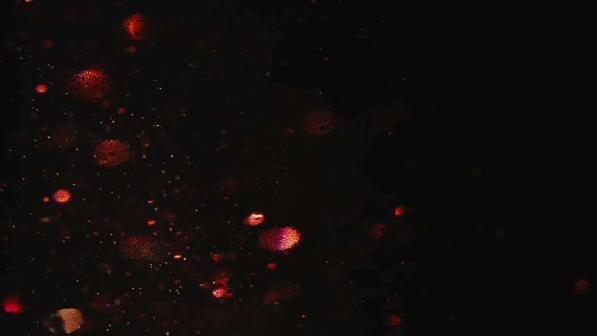 Red liquid with glitter in abstract rotating motion