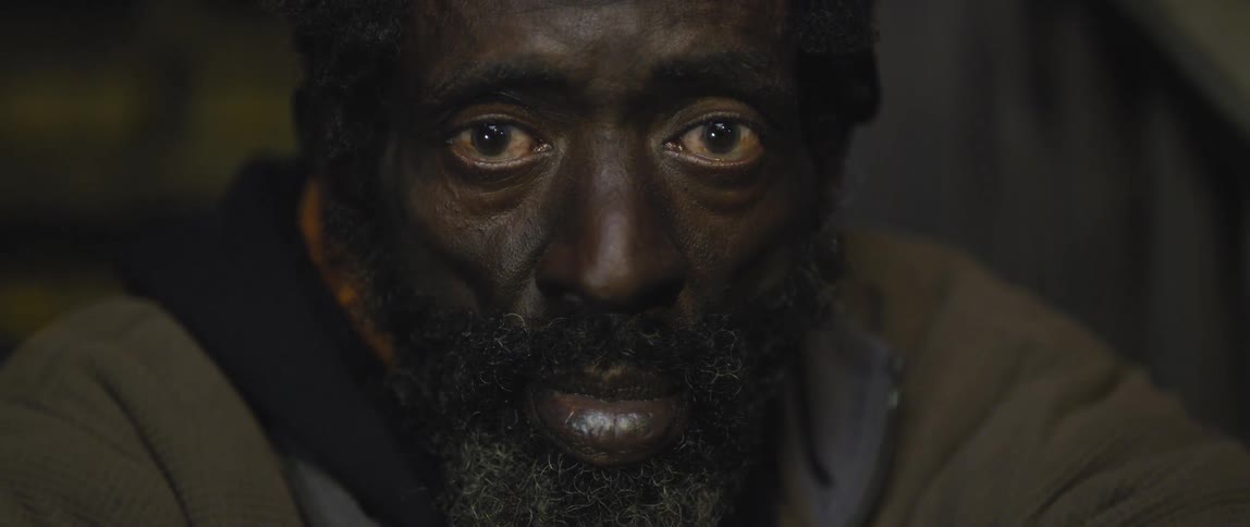 Depressed looking man sitting outside