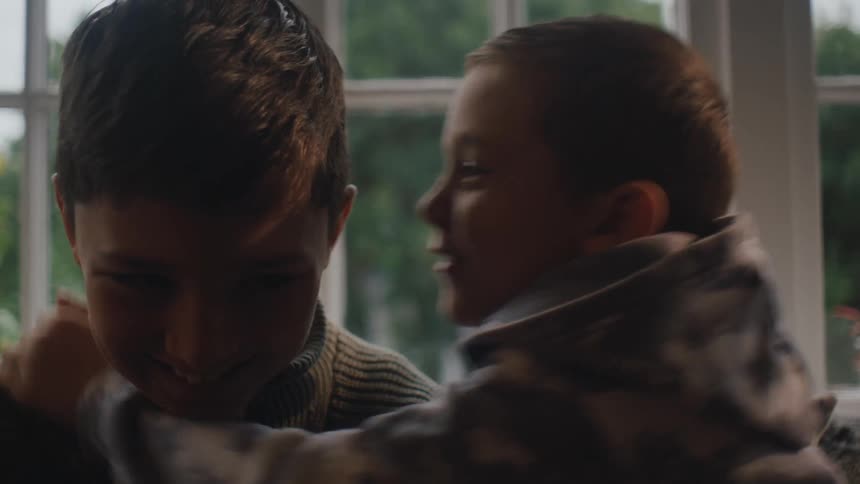 Two boys whispering and laughing