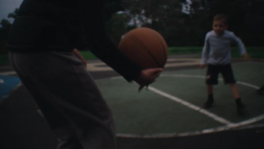 Children playing basketball on an open court