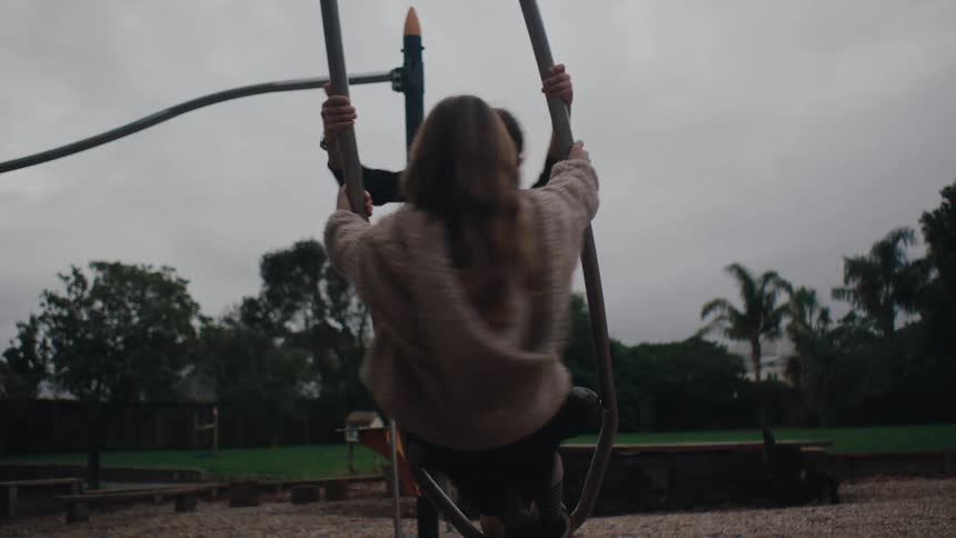 Two girl friends playing on an openair playground