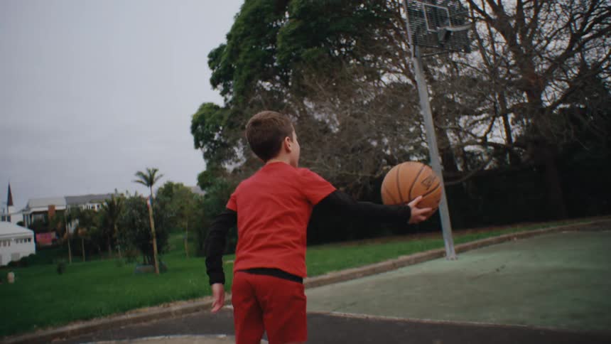 Boy playing basketball on a court