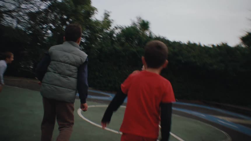 Boys and girls playing basketball on the court
