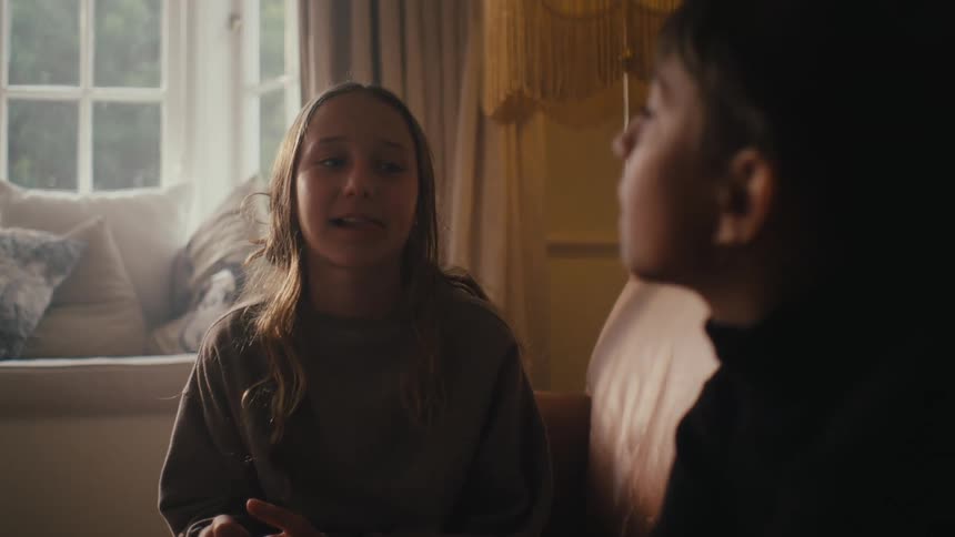 Two friends are talking on the couch