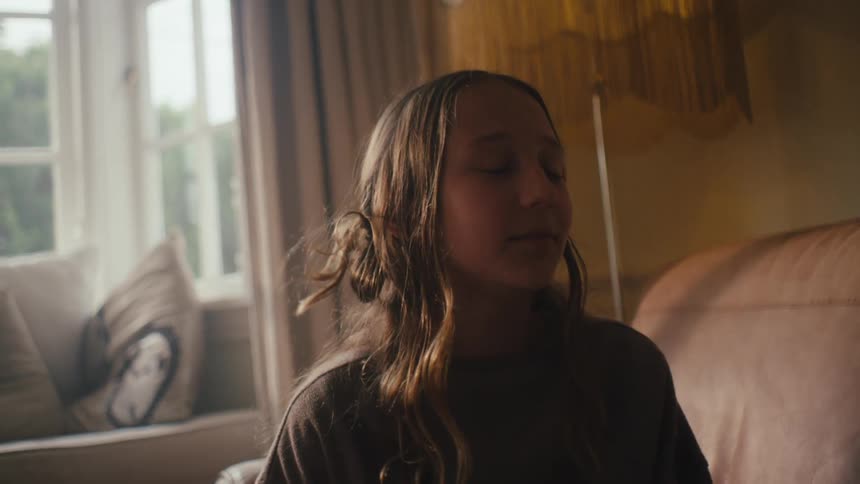 Portrait of a girl sitting in the living room talking