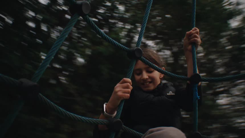 Little girl hanging from a spinning toy