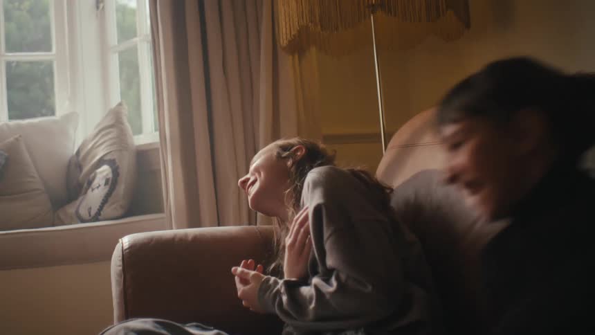 Two little girls in the living room playing and laughing
