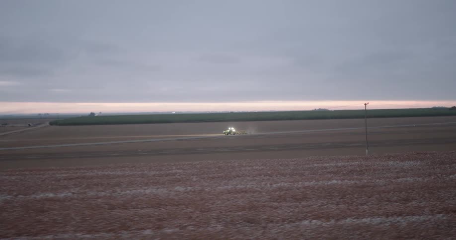 A tractor is driving across the farm
