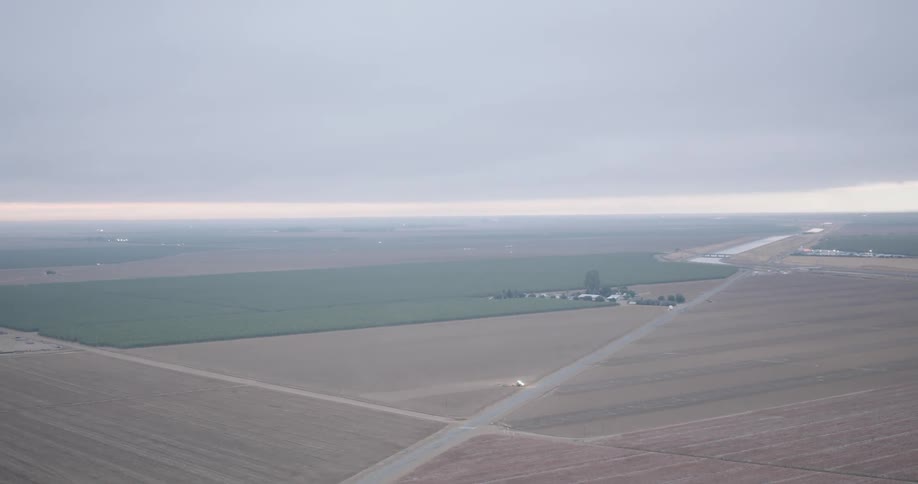 Aerial view of a large agricultural field on a cloudy day